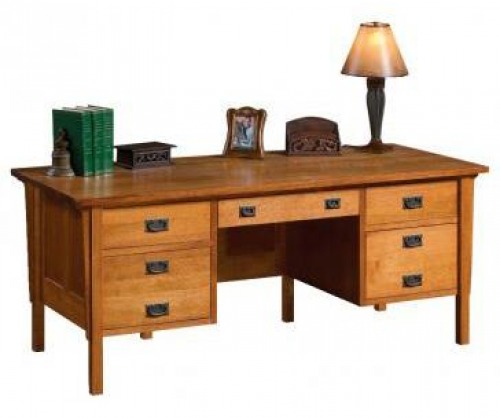The classic Gallatin executive desk with books, a lamp and picture frames on the desk with solid wood details
